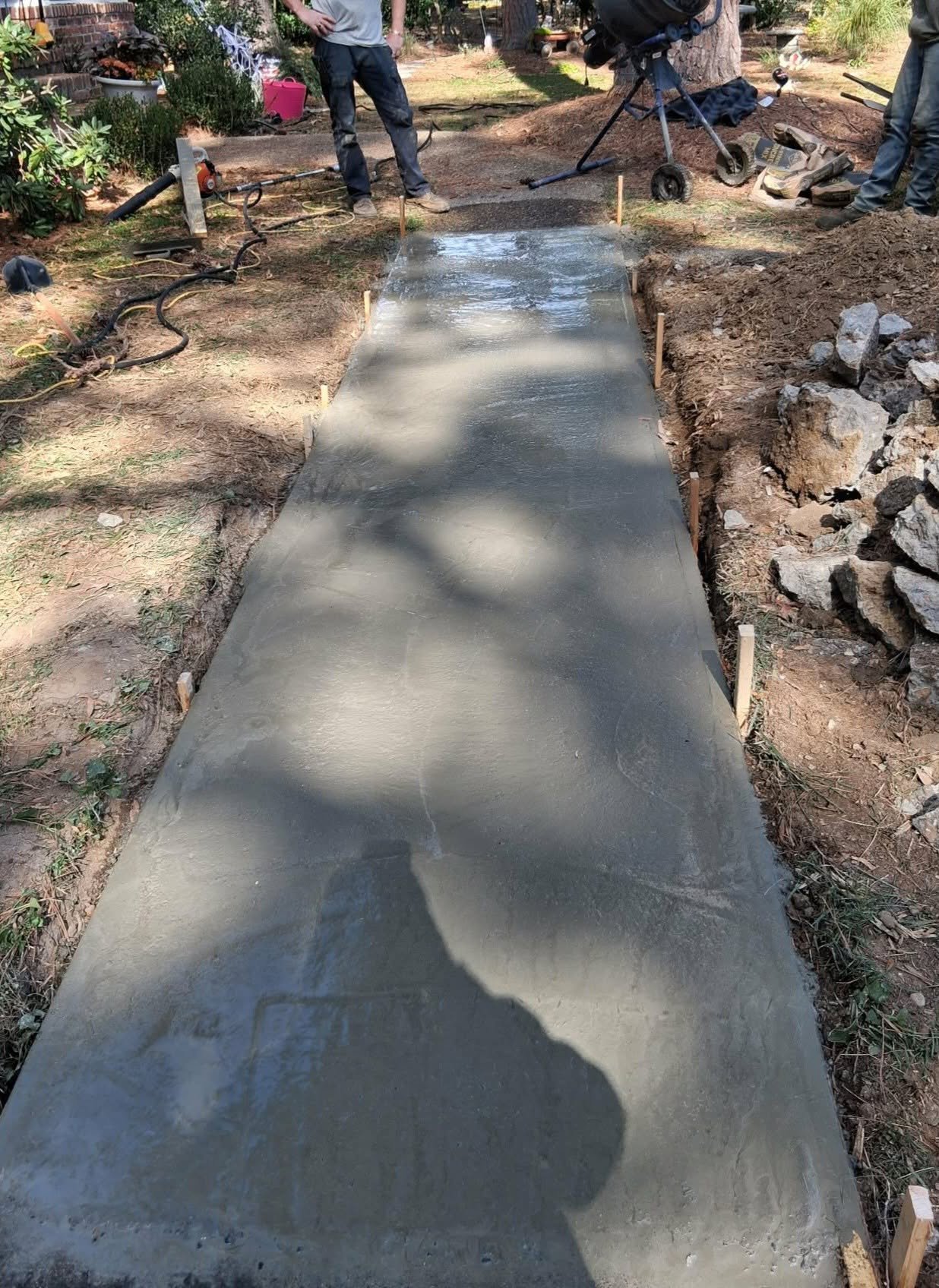 Crew finishing a smooth concrete walkway project